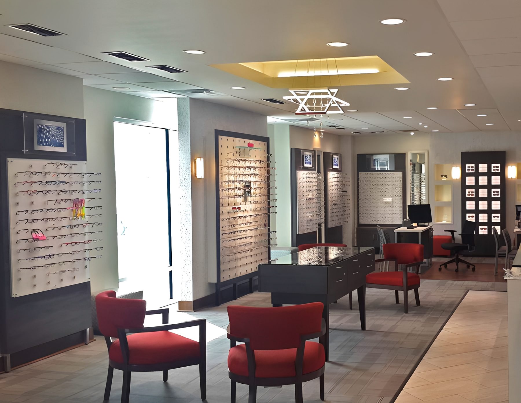 Brightly lit optician shop with red chairs
