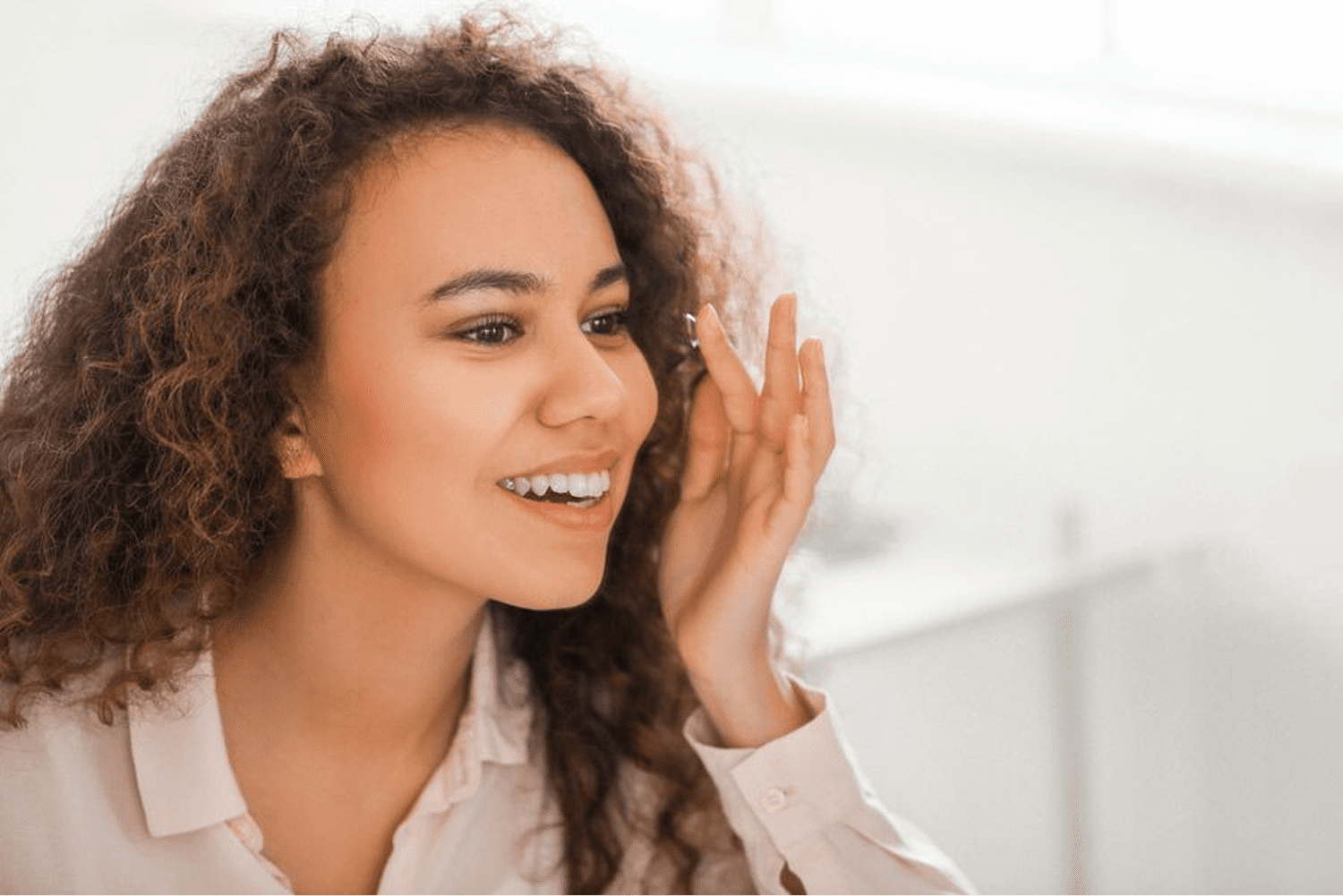 Smiling woman with curly hair indoors