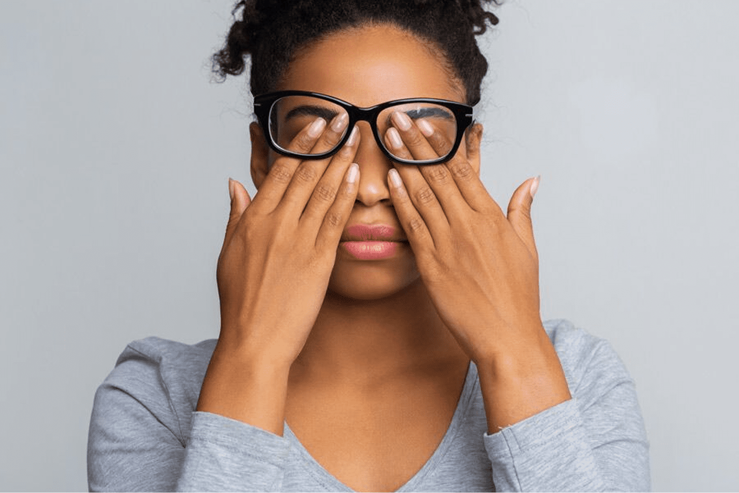 Person with glasses feeling fatigued