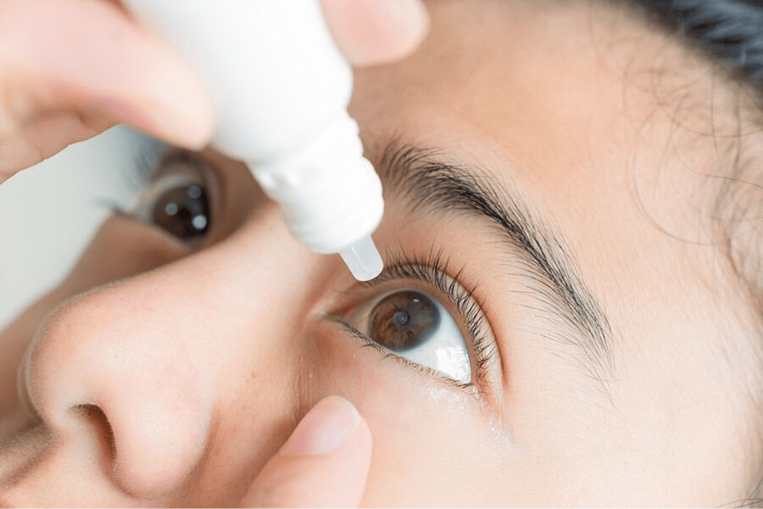 Applying eye drops to eye