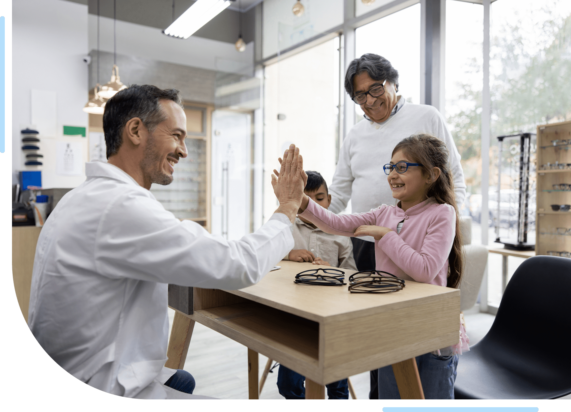 Optometrist high-fiving young girl